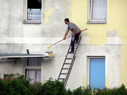 Man paints house