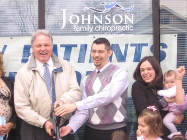 Mayor Mark Allen and Dr. Kyle Johnson prepare to cut the ribbon at the grand opening of Johnson Family Chiropractic of Peoria, IL.