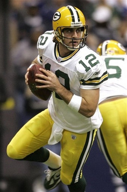 Aaron Rodgers holds a football